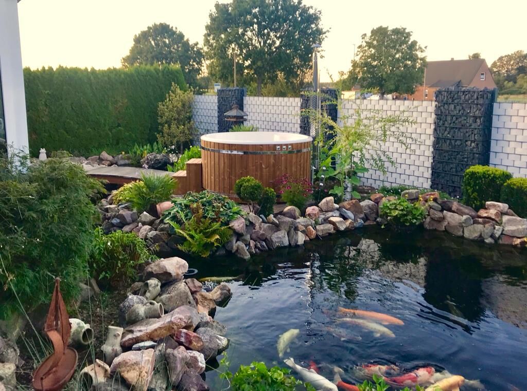 Badefass 200 Prestige rund Thermoholz mit integriertem Holzofen am Gartenteich